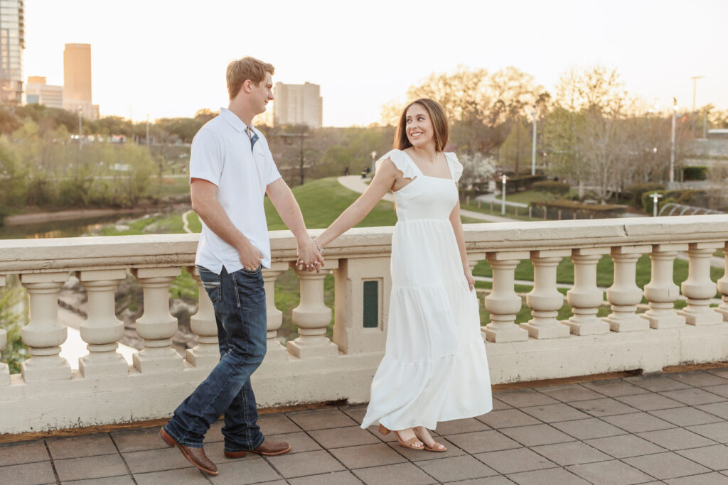 male and female couple pose for engagement photos at the sabine street bridge