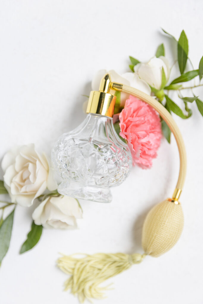 olde dobbin station wedding details photos - perfume bottle surrounded by florals